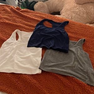 3  (cropped) tank tops. blue, white and gray.